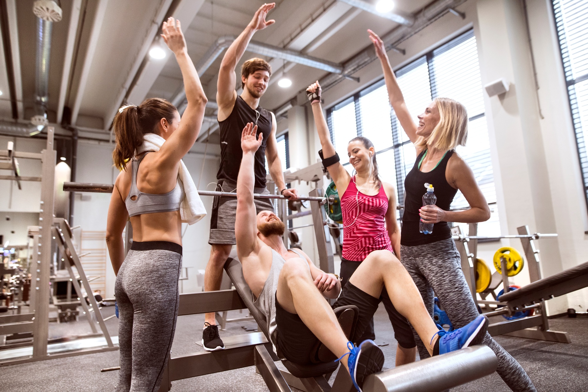 Group of people in gym training weight lifting