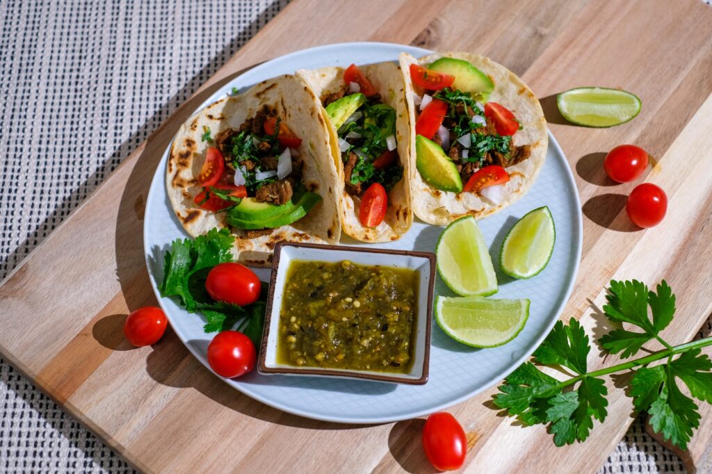 Taco with lime ,tomato and salsa . healthy diet food .